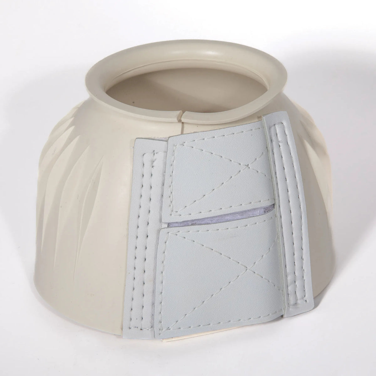 Professional’s Choice Rubber Open Bell Boots in cream. These durable, heavy-duty rubber hoof boots feature a secure double-locking hook and loop closure with reinforced stitching for a custom fit. The ribbed exterior and rolled top edge provide superior overreach protection and comfort for your horse during training or turnout. High-quality equestrian gear essential for horse hoof health and safety.