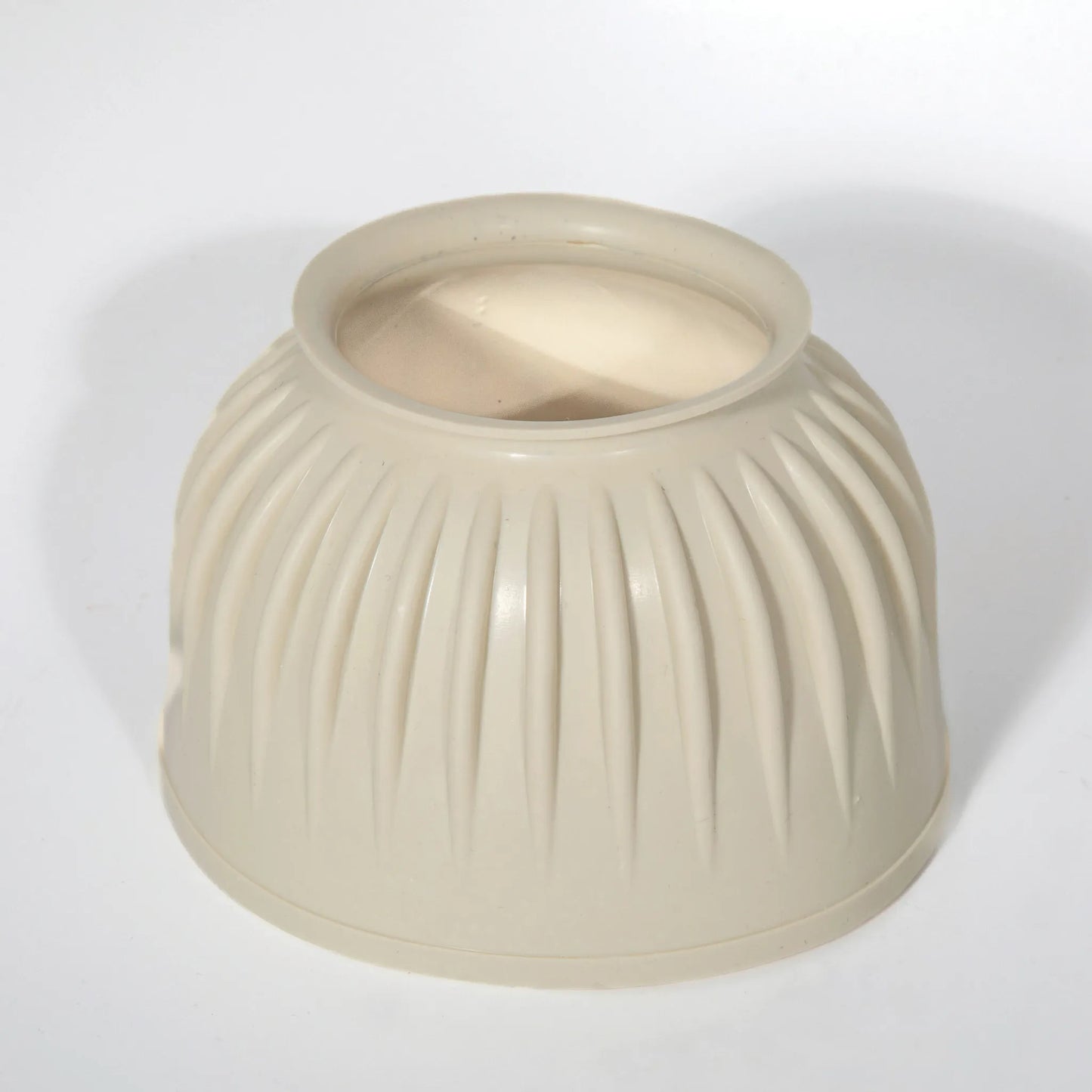 Professional's Choice natural cream rubber bell boot for horse hoof protection. Features a durable, heavy-duty ribbed design to prevent overreaching injuries and impact damage. This essential equestrian gear offers a secure fit and shock absorption for turnout or riding, ensuring long-lasting performance and safety for your horse's hooves.
