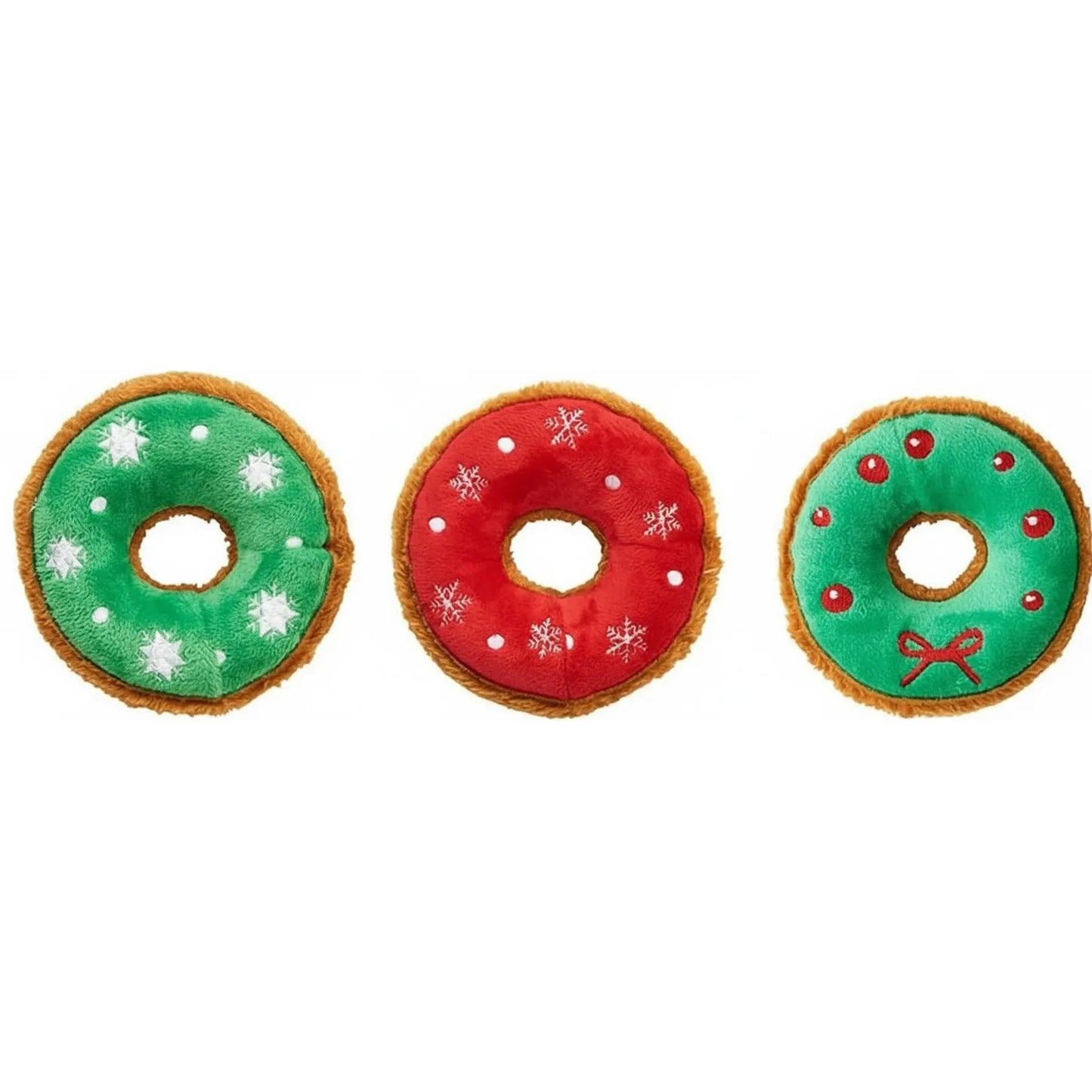 Set of three festive holiday plush donut dog toys from Ethical Pet SPOT. These 5.5-inch squeaky toys feature soft, colorful icing: one green with white snowflakes, one red with white snowflakes, and one green wreath design with red berries and a bow. Each plush toy has a fuzzy brown crust, making them the perfect festive Christmas gift for your pup to squeak and snuggle.
