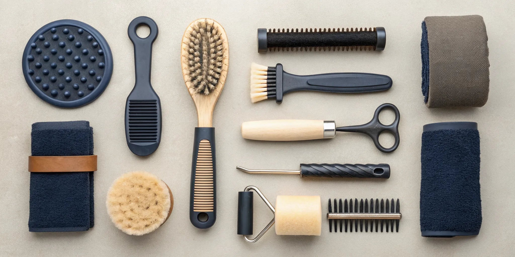 An essential horse grooming kit with a curry comb, various brushes, a hoof pick, and a mane comb.