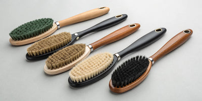 A selection of horse brushes with handles designed for a perfect coat.