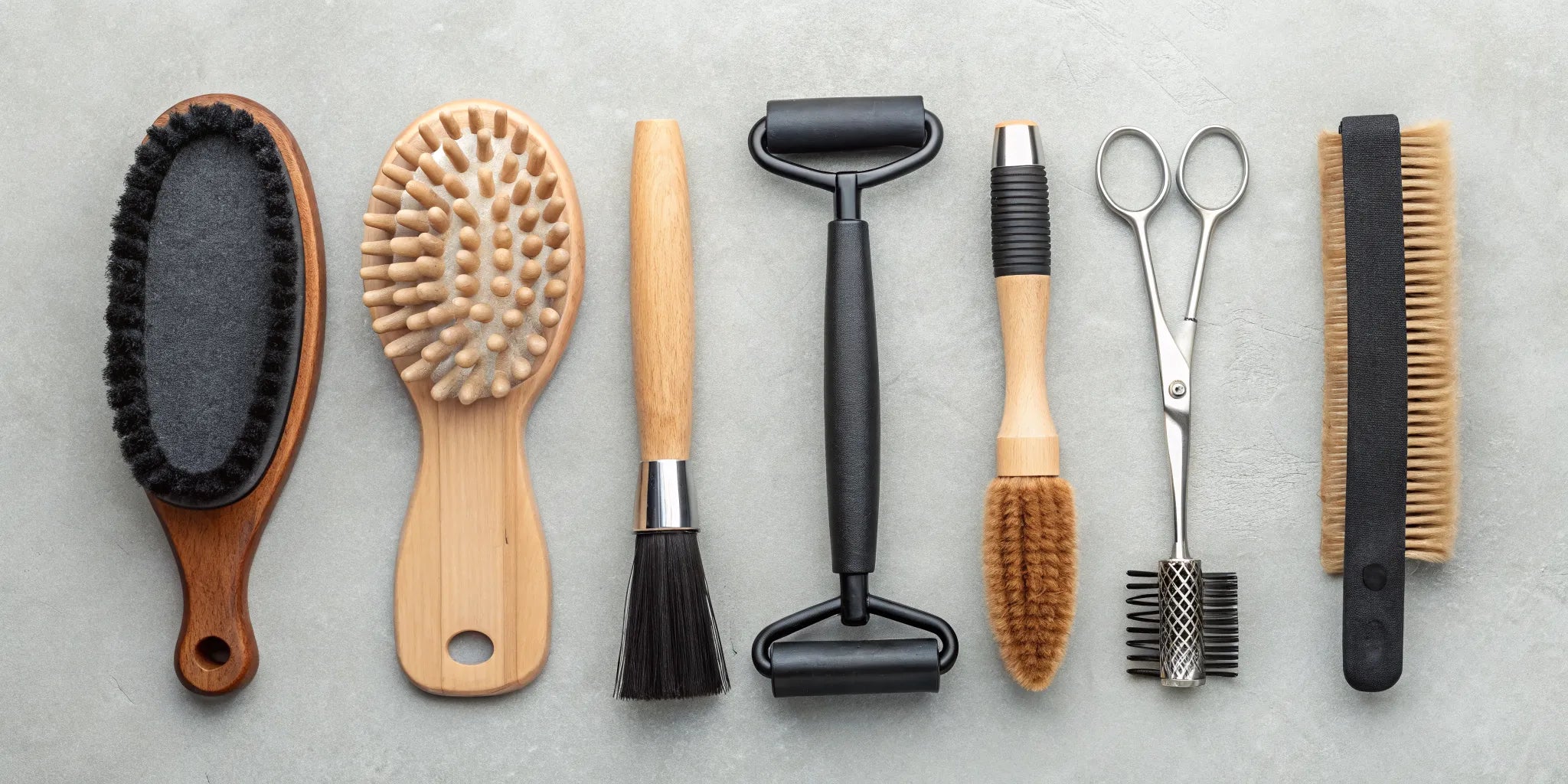 A variety of horse brushes for shedding, including curry combs and shedding blades.