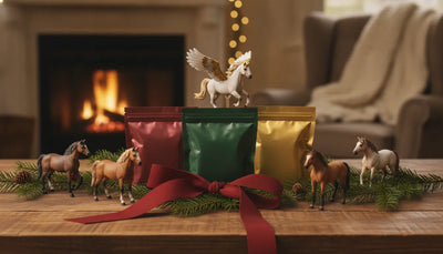 Miniature model horses and mystery gift bags arranged on a festive tabletop