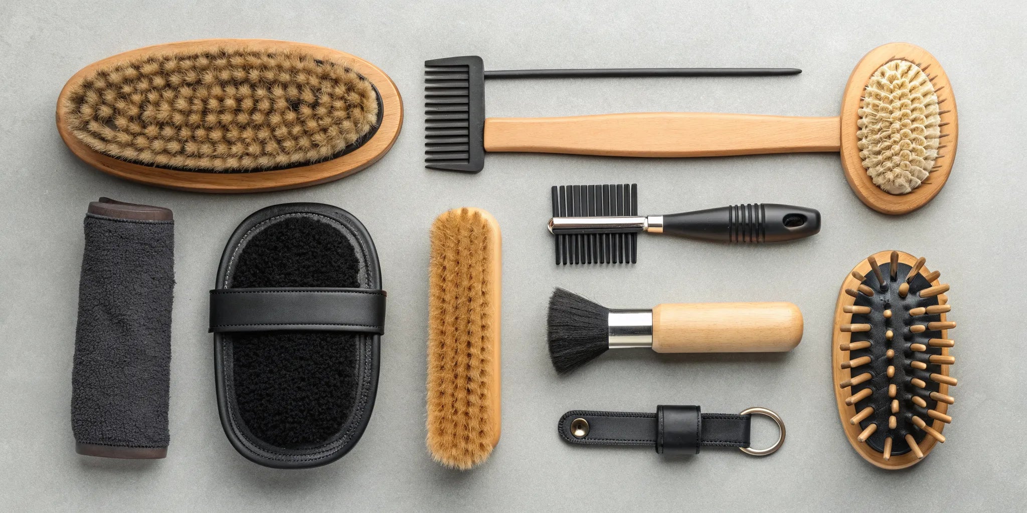 A variety of horse grooming brushes for sale, including curry, dandy, and body brushes.