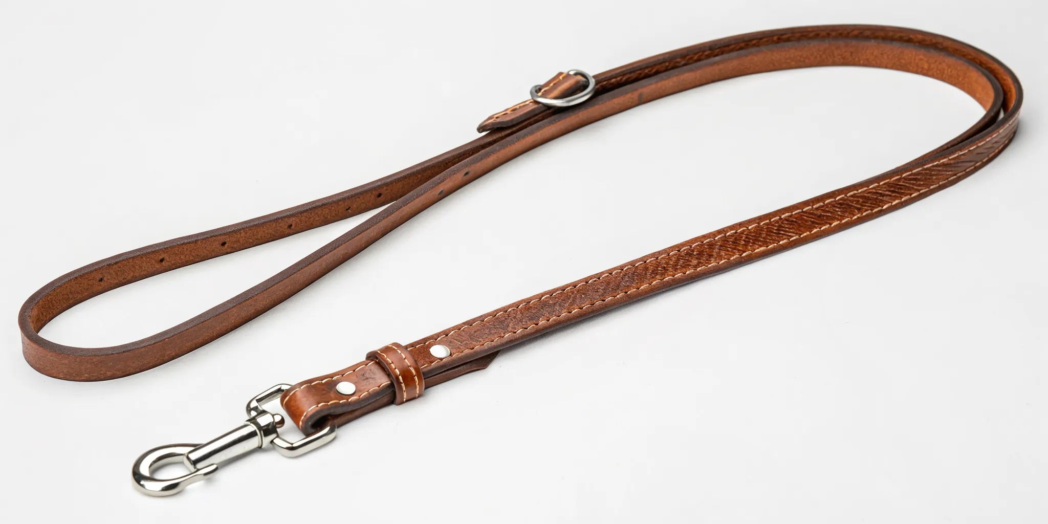 A brown leather barrel rein at the proper length for control and speed in barrel racing.