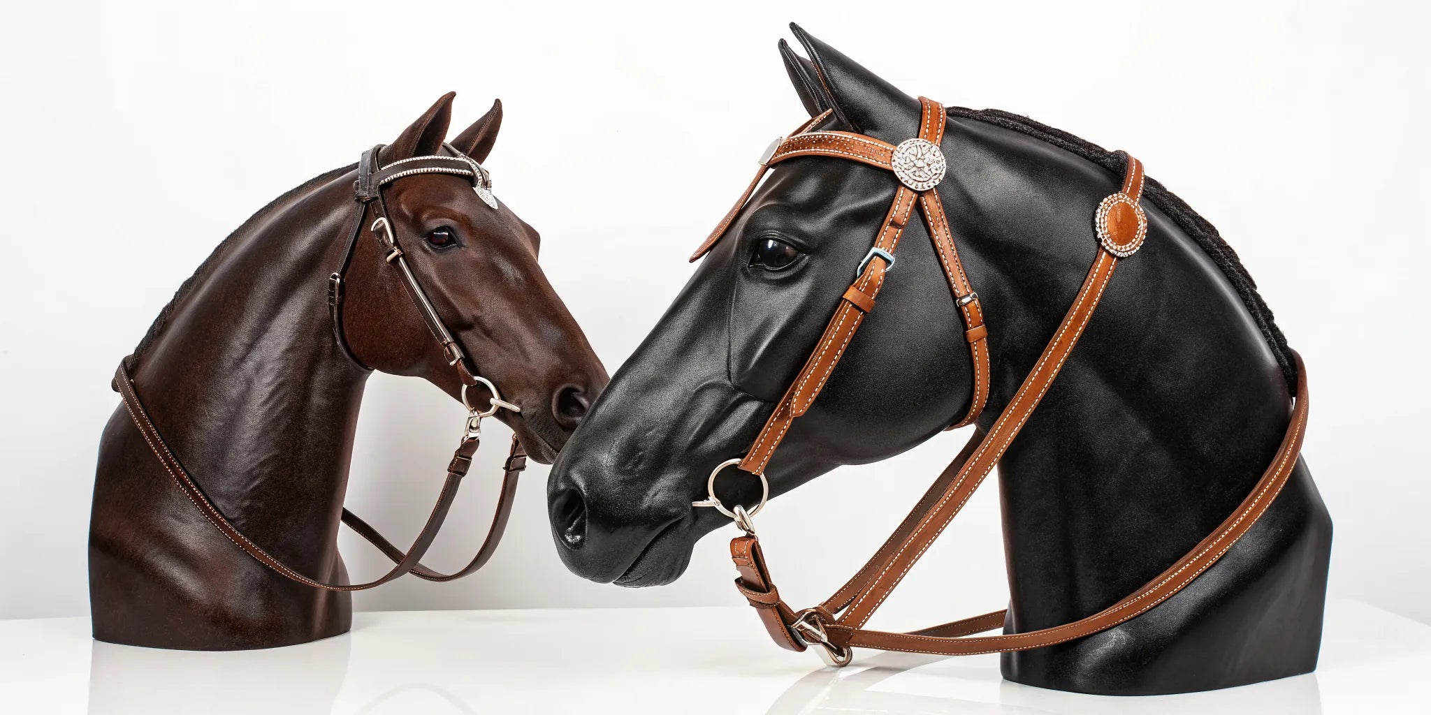 Two different leather Western headstalls on display to help a rider choose a style.