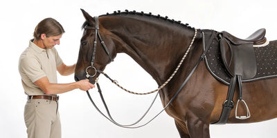 A person showing how to measure a horse's back for a saddle.