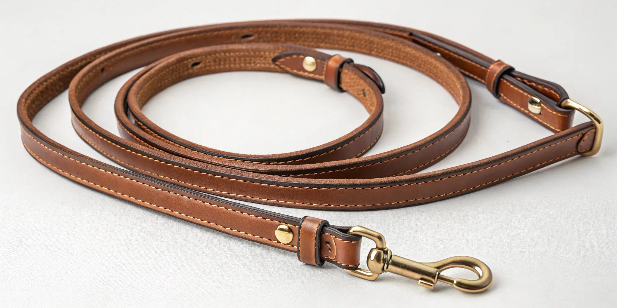 Leather barrel reins with knots and brass hardware for better grip and control.