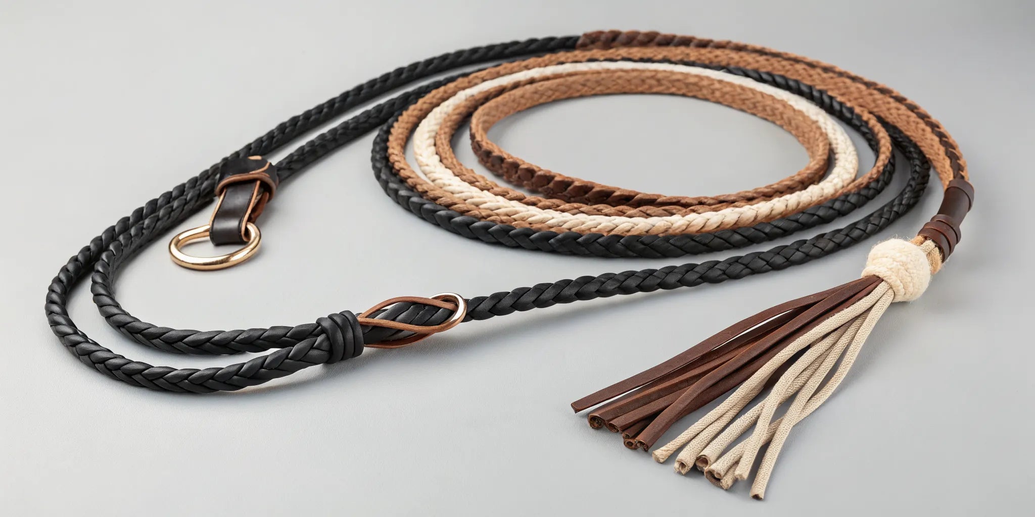 Mecate reins braided in black, brown, and tan with leather slobber straps and a popper.