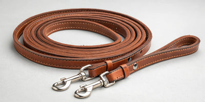 Coiled leather split reins with quality hardware for western riding and ranch work.