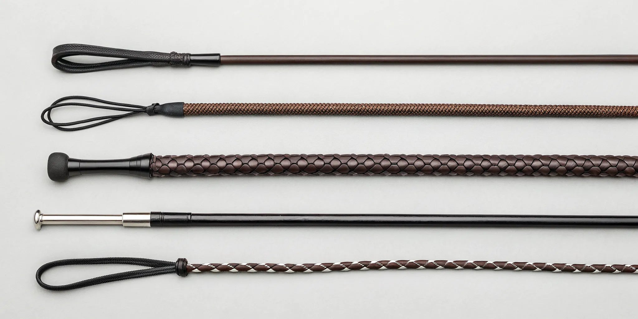 A variety of horse whips for different riding disciplines like dressage, jumping, and groundwork.