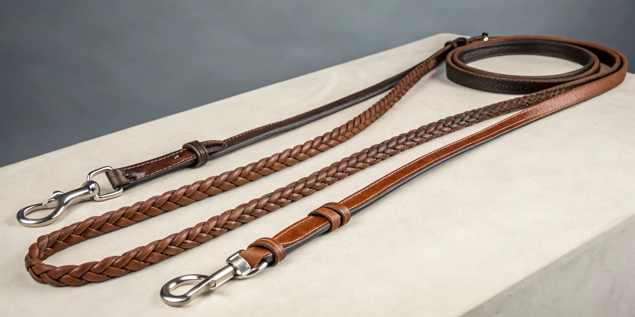 A selection of leather roping reins in various lengths for comparison.