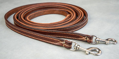 Leather roping reins for horses with durable stitching and metal hardware.