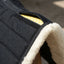 *Alt Text: Lifestyle photograph of the Toklat Matrix Endurance English saddle pad in use on a chestnut Arabian horse. The black pad with white fleece trim is under a brown endurance saddle. The horse is standing on a dirt path in a sunlit, rustic paddock setting.*

#### **3. Close-up Detail Shot**

This image provides a close-up view of the materials, stitching, and the unique insert system.