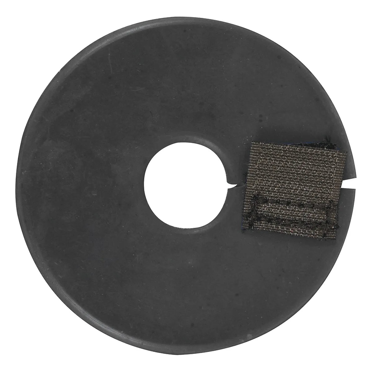 Single black Cashel Bit Cheek Guard made of soft rubber to protect a horse's mouth from pinching and rubbing. Features a circular design with a center hole and a side slit secured by a black nylon hook-and-loop closure for easy application over bit rings. Ideal for improving horse comfort and bit stability in any riding discipline. High-quality equestrian tack accessory for performance and protection.