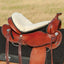 Cashel Fleece Tush Cushion in natural cream, designed to provide superior comfort and pressure relief for riders. This plush fleece seat saver is shown securely fitted onto a brown leather Western saddle. A perfect equestrian accessory for long trail rides, the breathable synthetic fleece padding prevents soreness and fits most Western saddles. Enhance your horse riding experience with this durable, high-quality saddle seat cushion.