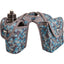 Cashel Horn Saddle Bag featuring a vibrant blue and teal geometric triangle pattern. This Western saddle horn bag includes a dedicated bottle holder with an included black water bottle and a spacious storage compartment for lunch or trail gear. Designed for durability with grey trim and an easy-fit opening for saddle horns, it is the perfect equestrian accessory for horseback riders staying organized and hydrated on long trail rides.