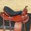Cashel Western Luxury Tush Cushion in black, featuring 1/2 inch foam for enhanced rider comfort. This sleek black seat saver pad is shown fitted on a brown leather Western saddle, offering a soft, ergonomic layer to reduce fatigue during trail rides. High-quality foam padding designed specifically for Western saddles to provide a luxurious riding experience. Ideal for equestrian enthusiasts looking for saddle comfort accessories.