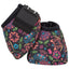 Classic Equine Dyno No-Turn Bell Boots in a vibrant floral and paisley print. These protective horse boots feature a colorful pattern of pink, orange, blue, and green flowers on a black background. Shown with a secure black hook-and-loop closure and a "NO-TURN" rubber tab, these boots offer durable hoof protection with a fun, stylish flair. Ideal for performance horses or daily riding, combining high-quality equestrian gear with eye-catching western style.