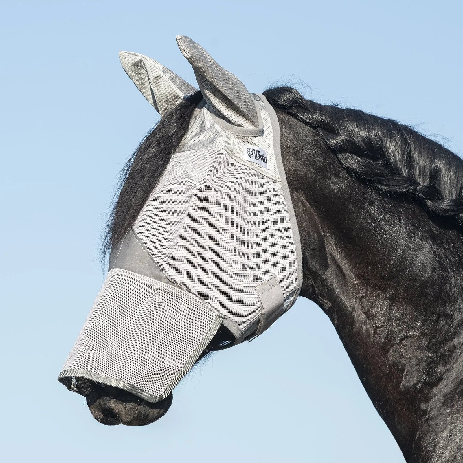 Cashel Crusader Sun Fly Mask in grey on a black horse, featuring full-face coverage with ears and a long nose. This breathable mesh fly mask provides ultimate UV and fly protection, shielding horses from harmful sun rays and biting insects. A high-quality equestrian accessory designed for pasture comfort, durability, and effective sun safety.