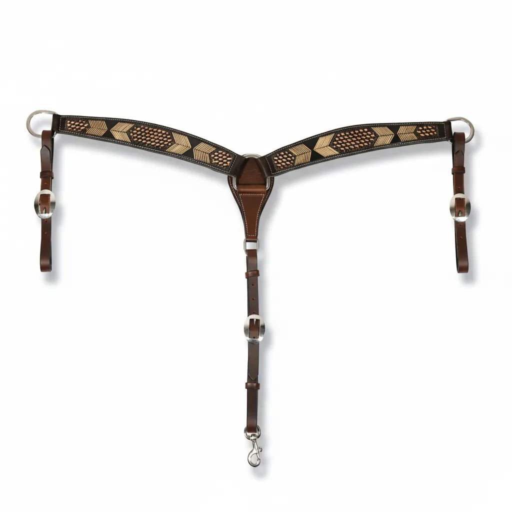 Professional's Choice chocolate hand-tooled leather breast collar featuring a detailed arrowhead and basketweave pattern. This 2-inch wide western horse tack includes adjustable tug straps with classic silver-toned buckles and a center snap for secure attachment. Crafted for durability and style, it's perfect for barrel racing, trail riding, or everyday performance. Standard horse size.