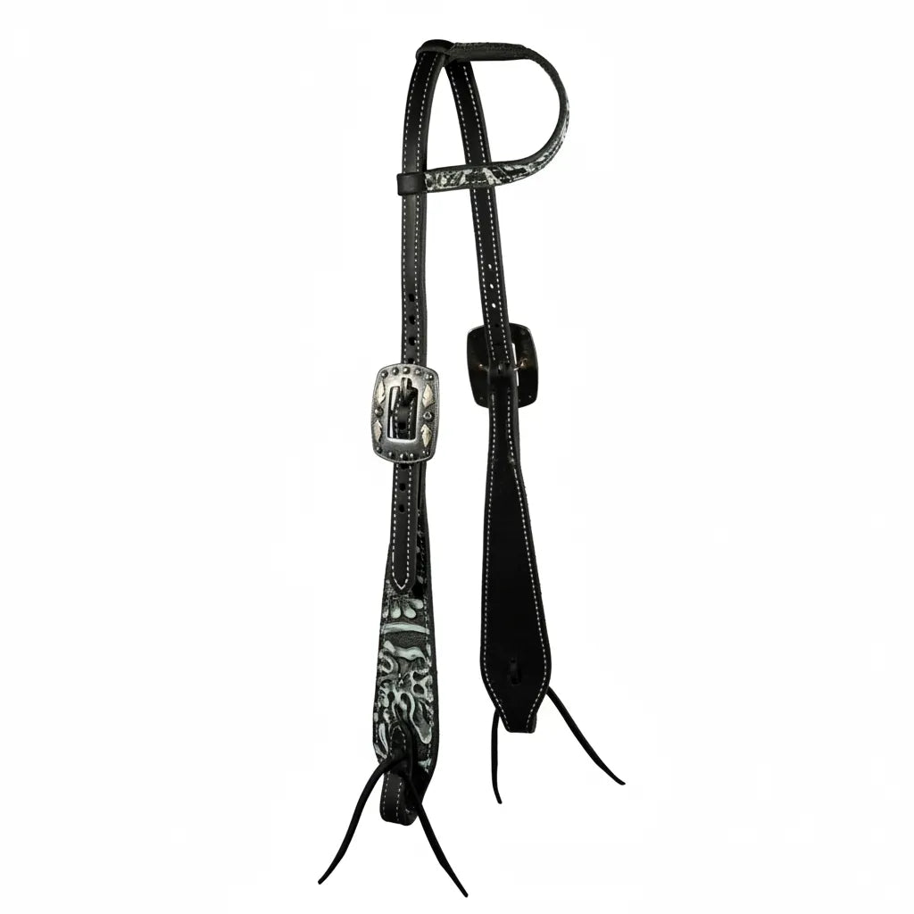 Professional's Choice Paisley Swell Cheek Headstall crafted from black latigo leather with white contrast stitching. This Western headstall features a striking white paisley pattern on the browband and swell cheeks, accented by ornately engraved silver buckles. Designed with leather bit ties for a classic look, this high-quality equestrian tack offers both style and durability for trail or arena performance.