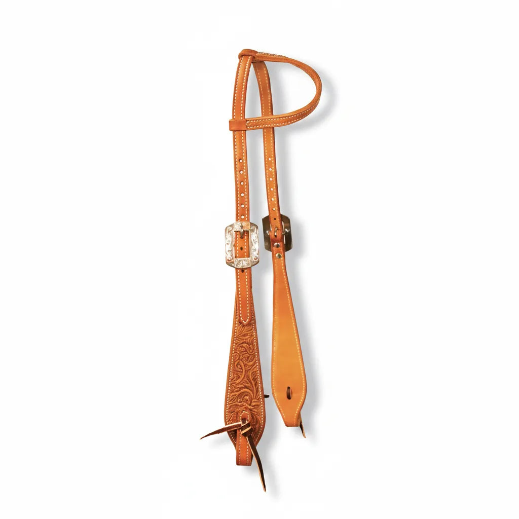 Professional's Choice High Desert Floral Tooled 1-Ear Headstall crafted from rich chestnut leather. Features intricate hand-tooled floral patterns on the flared cheeks, decorative white stitching, and stunning engraved silver buckles. This high-quality Western horse tack combines durability with show-ring style, perfect for trail riding or ranch work. Adjustable straps with leather tie-bit ends ensure a secure, custom fit for your horse.