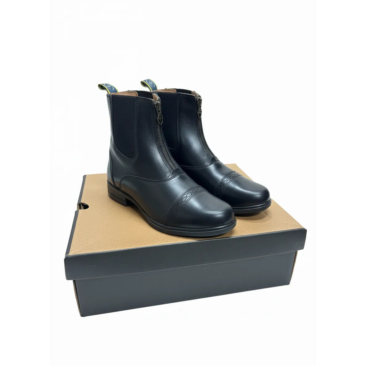 Shires Rosetta Paddock Boots in black premium full-grain leather, adult size 8. These gently used equestrian riding boots feature a convenient front zipper, elastic side gussets for comfort, and elegant decorative punched toe caps. Perfect for horse riding and stable wear, the classic English riding boots are displayed on their original shoe box, showcasing the durable leather construction and pull tabs for easy wear.
