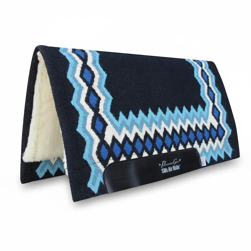 Professional's Choice SMX Heavy Duty Air Ride Shiloh Saddle Pad featuring a hand-woven Navajo wool top in black with vibrant blue, light blue, and white geometric patterns. This 34" x 36" western pad includes a 3/4" shock-absorbing core and soft white fleece lining for horse comfort. Durable black leather wear leathers display the SMx Air Ride logo and a small USA flag, showcasing premium craftsmanship for show or trail riding.