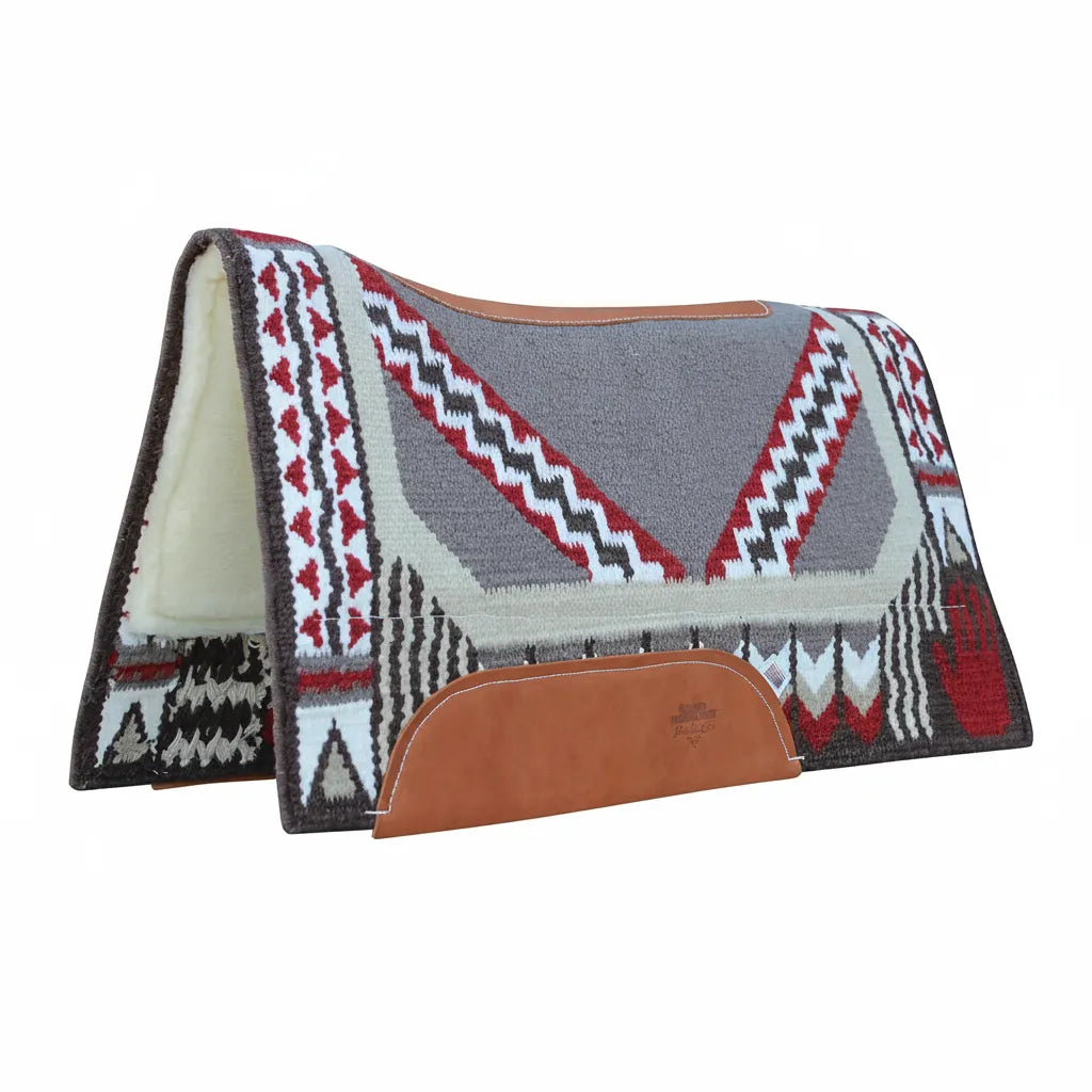 Professional's Choice Good Medicine Comfort-Fit SMX Air Ride Western Saddle Pad with a New Zealand wool top in a gray, red, and cream Southwest geometric pattern. This contoured horse pad features a premium leather spine, durable wear leathers, and a plush cream fleece lining. Designed for impact protection and comfort, it showcases a striking "Good Medicine" hand design, perfect for western riders seeking high-performance equestrian gear with traditional style.