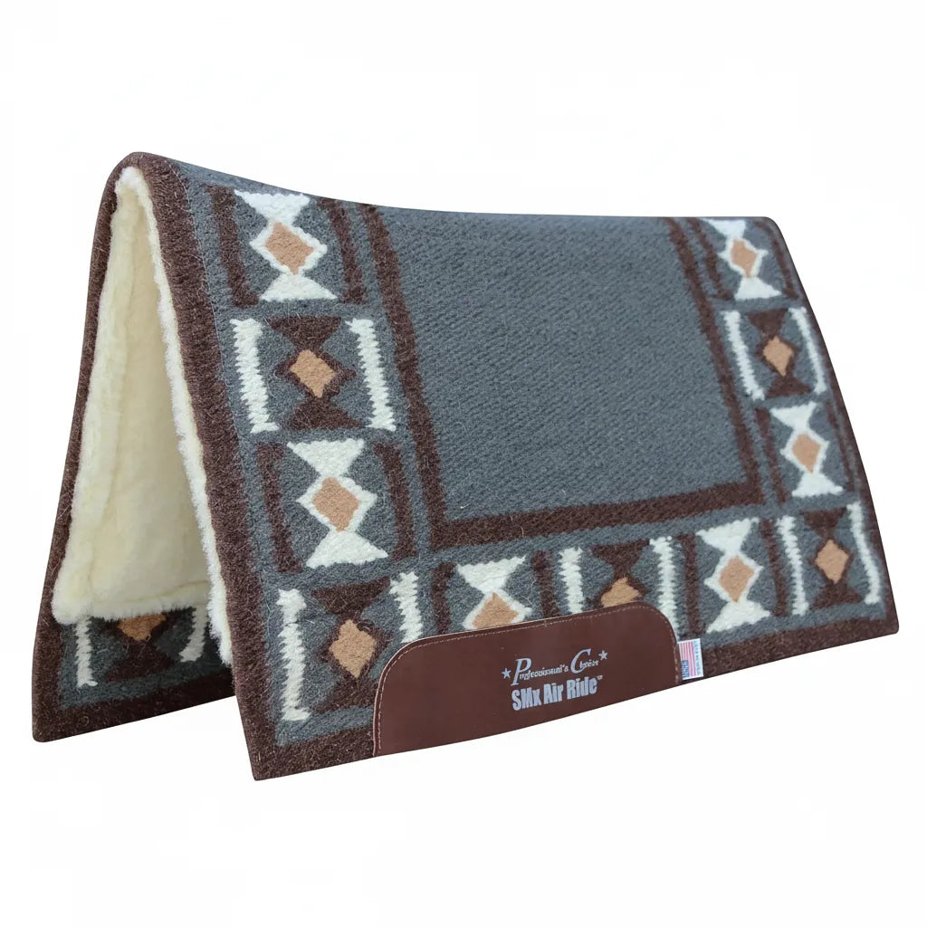 Professional's Choice Comfort-Fit SMX Air Ride Hourglass Saddle Pad featuring a woven wool Navajo design in charcoal grey, chocolate brown, and cream geometric patterns. This shock-absorbing Western saddle pad includes a thick white fleece underside for horse comfort and durable leather wear leathers with a branded logo. Perfect for Western riding and ranch work, providing a contoured fit and high-performance protection for your horse.