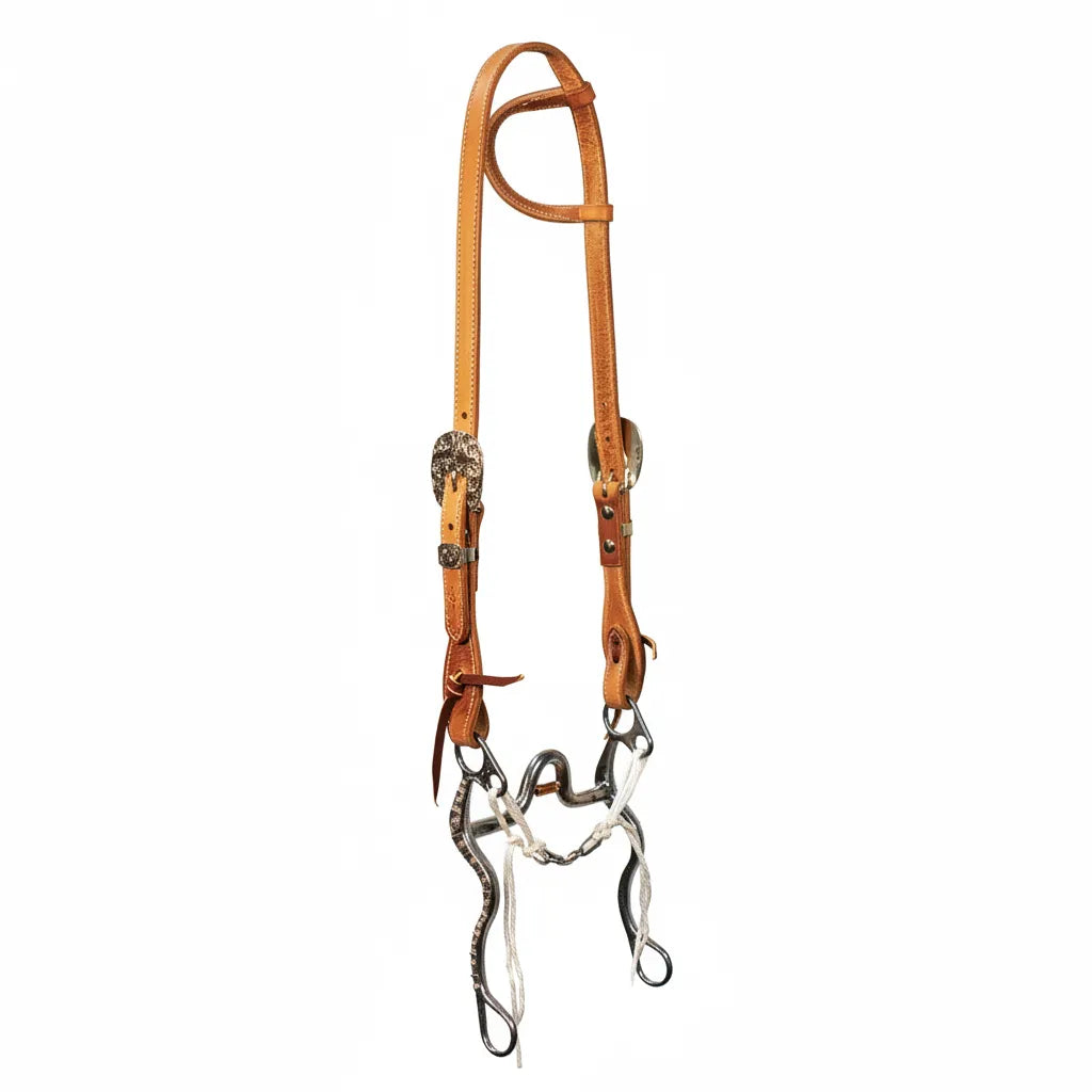 Professional's Choice PC 50 Anniversary light oil leather one-ear headstall with ornate silver-engraved buckles and conchos. This premium western horse bridle features a decorative silver-accented curb bit and white rope curb strap. High-quality western tack for horse showing, ranch work, or pleasure riding, showcasing expert craftsmanship and timeless style.