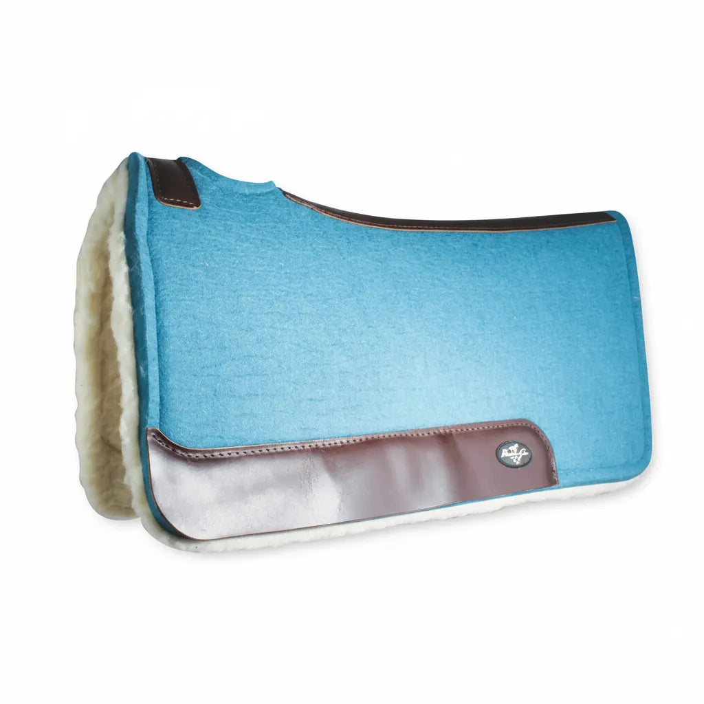 Professional's Choice turquoise 100% wool felt contoured saddle pad featuring dark brown leather wear leathers and a plush fleece lining. Designed for superior pressure relief and moisture wicking, this anatomical Western saddle pad offers a secure, comfortable fit. The steam-pressed felt and durable leather reinforcements make it a stylish and functional choice for equestrian performance and trail riding.