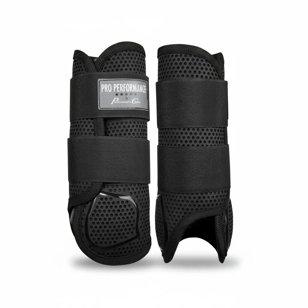 Professional's Choice Pro Performance Elite XC Boots in black. This front pair features a breathable TPU honeycomb exterior and a tough Pebax strike guard for superior impact protection. Designed with secure double hook-and-loop closures, these medium horse boots provide lightweight, ventilated leg protection ideal for cross-country riding, eventing, and high-performance equestrian sports. High-quality protective gear for elite horse athletes.