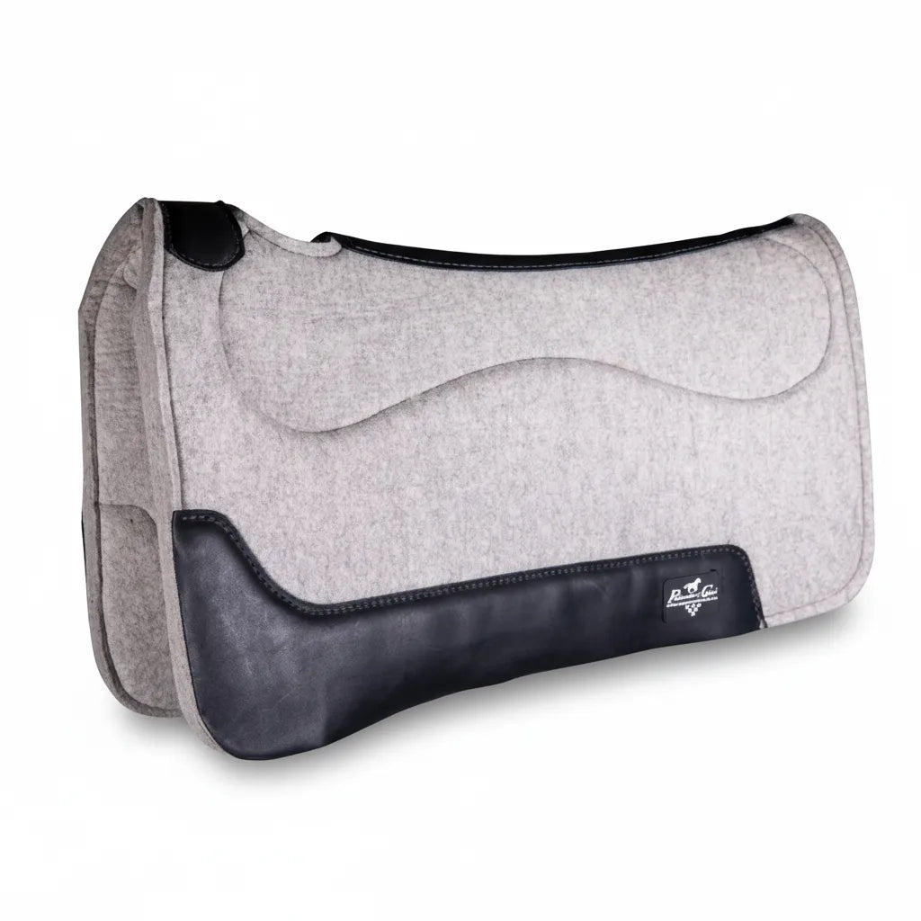 Professional's Choice Precision Relief Wool Felt Barrel Saddle Pad in grey with black leather accents. This 29-inch contoured western saddle pad features a tapered 1 1/8-inch to 3/4-inch wool felt construction for ergonomic pressure relief. Ideal for barrel racing, it includes premium leather wear leathers and a specialized wither cutout for a superior fit and horse comfort. High-performance equestrian gear designed for competitive riding and maximum support.