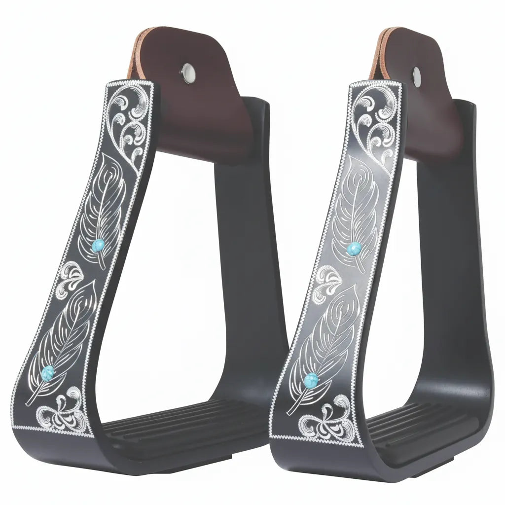 Professional's Choice Turquoise Feather Engraved Aluminum Western Stirrups. This pair features a matte black finish with intricate silver-engraved feathers and scrolls accented by small turquoise stones. These stylish western stirrups include dark brown leather necks with silver rivets and a 5 3/8" wide ribbed footrest. Perfect for barrel racing or show performance, these 3" neck aluminum stirrups combine durability with a unique, bold equestrian look.