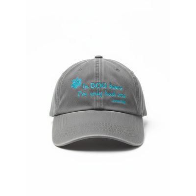 Lovewally In Dog Beers Embroidered Baseball Hat in charcoal grey. This adjustable 100% brushed cotton twill dad hat features vibrant cyan embroidery with a paw print and the funny quote, "In DOG beers I've only had one." A high-quality, stylish pet-themed accessory for dog lovers and beer enthusiasts, perfect for casual wear.