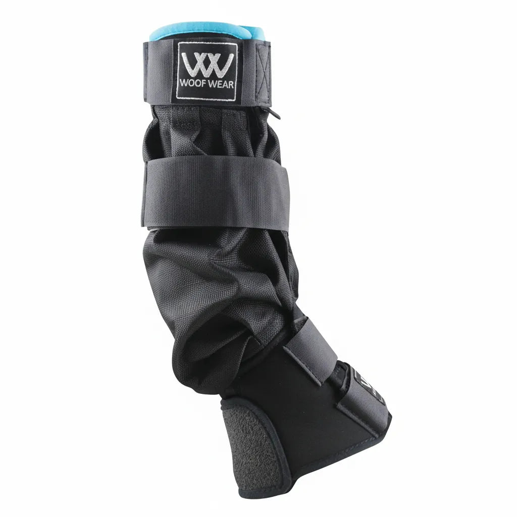 Toklat Woof Wear Mud Fever Boots in black with turquoise lining. These waterproof and breathable Kevlar turnout boots offer full-leg protection for horses in wet pastures. Featuring secure adjustable straps and a durable, flexible design, they are engineered to prevent mud fever by keeping legs dry and clean. High-performance equestrian protective gear perfect for turnout in muddy conditions.