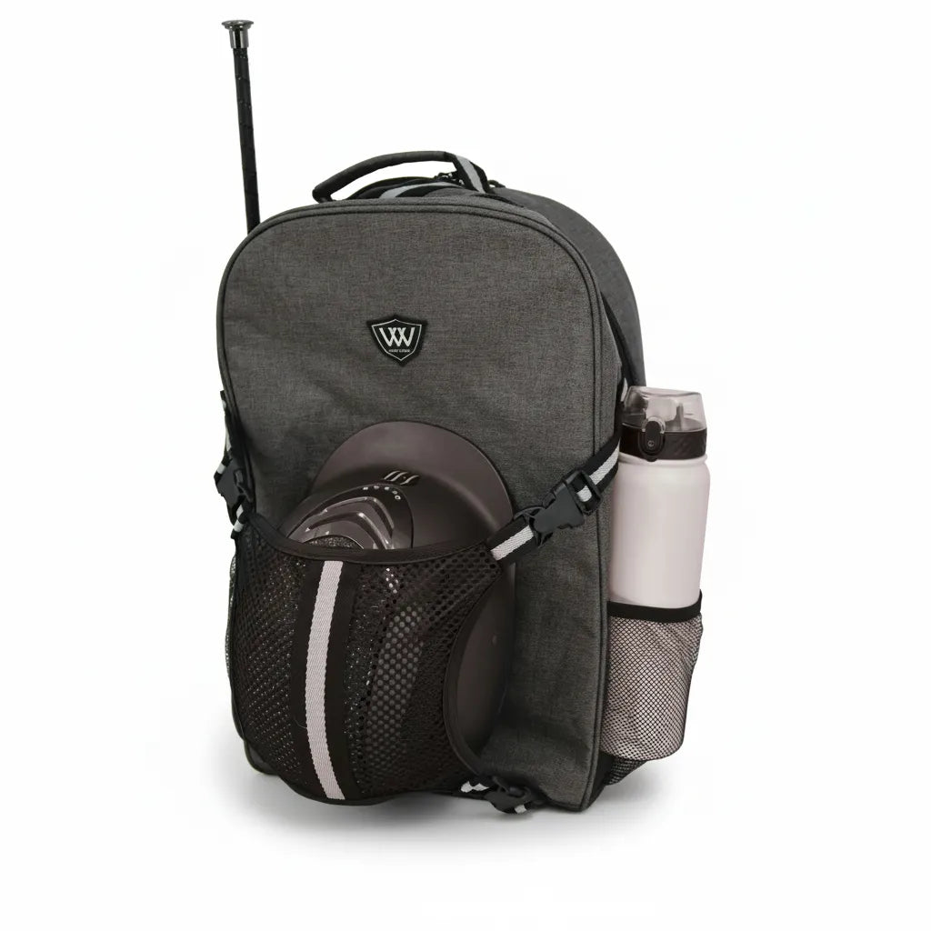 Toklat Woofwear Rider Commuter Backpack in grey and black reflective fabric. Features a front mesh net holding a brown riding helmet, a side slot for a riding crop, and a mesh water bottle pocket. This equestrian gear bag includes a 15-17" laptop sleeve and reflective safety strips, making it the perfect stylish and functional backpack for horse riders traveling to the barn or show.