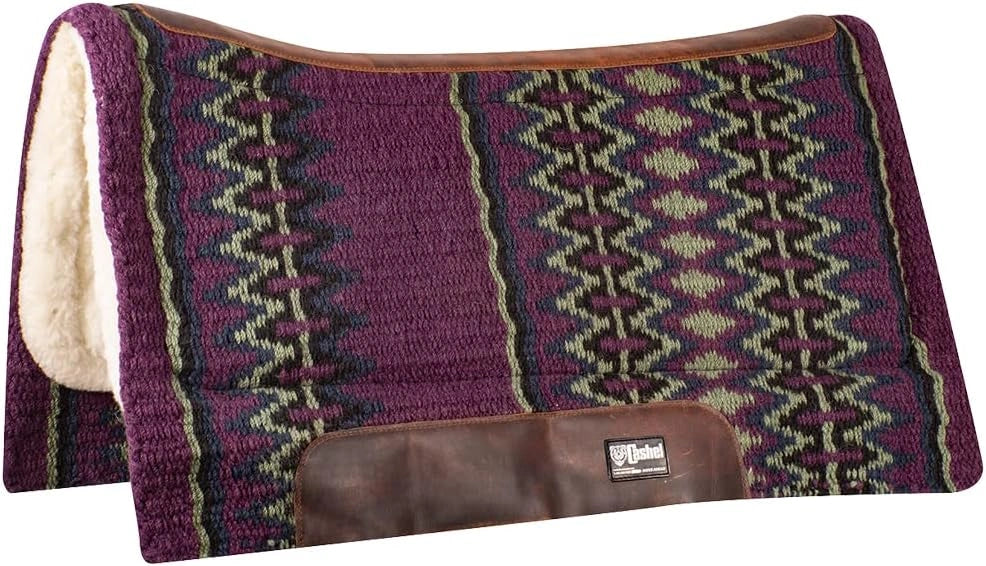 Patterned saddle pad with brown border and visible brand logo on a white background