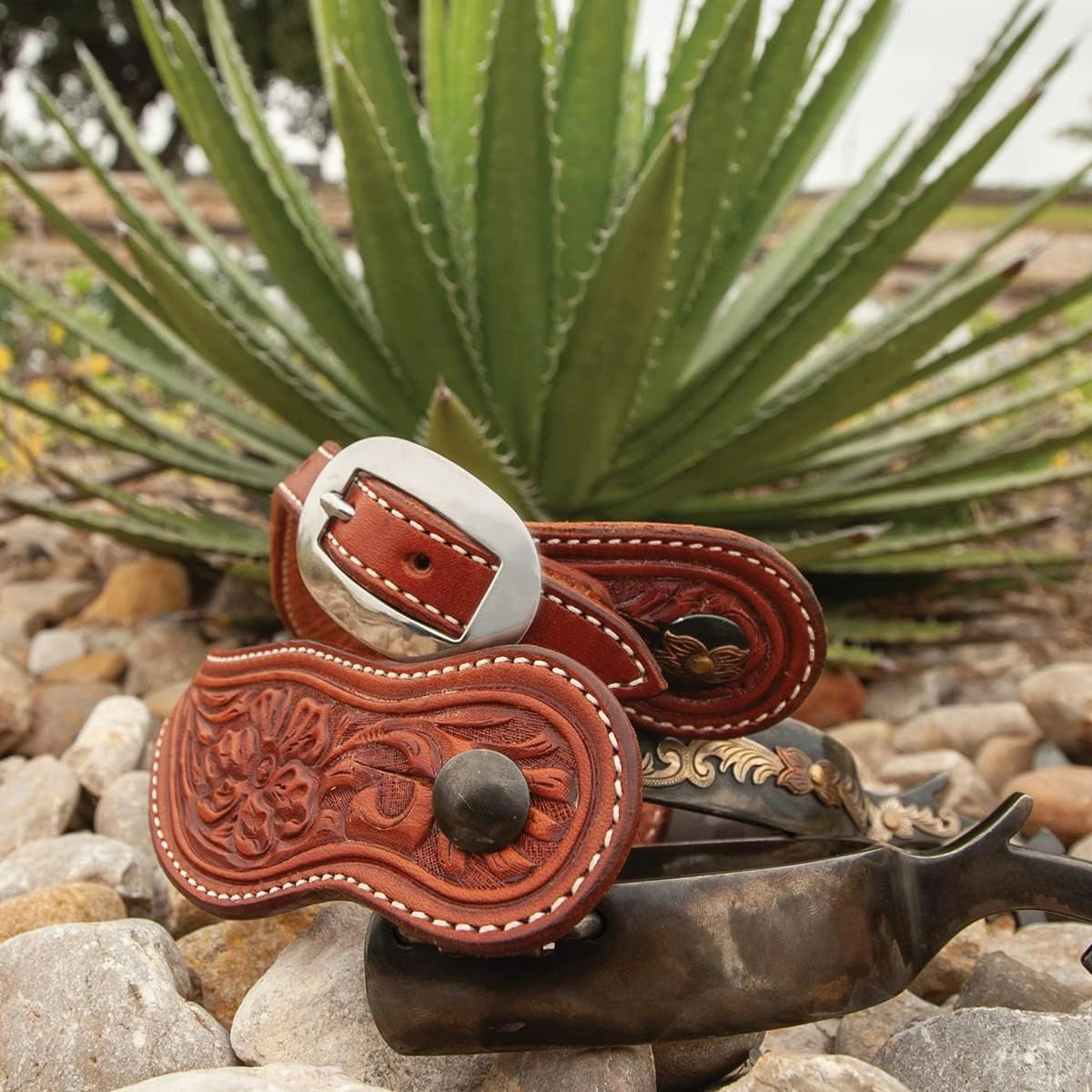 Alpine Flower Tooling Cowboy Spur Straps - Chestnut Leather, displayed with professional product photography
