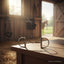 Stainless steel Myler MB 32 Dee Snaffle horse bit on a wooden table in a sunlit barn, with a blurred horse visible through an open door. Dressage legal.