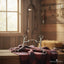 Myler MB 05 Comfort Snaffle horse bit with sweet iron and copper inlay, displayed on a red and dark plaid blanket on a rustic wooden stable surface. A sunlit window and blurred horse tack are visible in the background, emphasizing a quality horse training product.