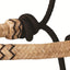 Beige and black braided leather bracelet on a white background