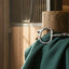 Myler 04 Stainless Steel Eggbutt with Hooks horse bit displayed on a dark green blanket in a rustic wooden barn.
