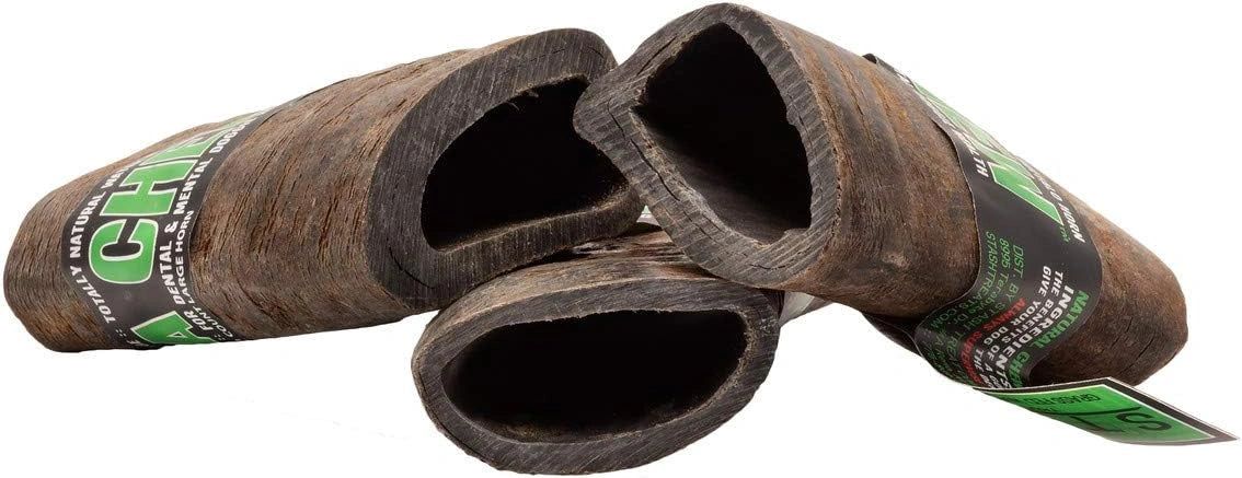 Wooden duck call with green label on a white background