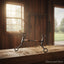 Myler MB 09 Tom Thumb Snaffle Bit, sweet iron with copper inlay, resting on a rustic wooden surface in a sunlit barn.