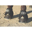 Professional's Choice black Ballistic Bell Boots provide ultimate hoof protection on a horse's feet. These durable equestrian overreach boots feature high-quality ballistic nylon and a secure hook-and-loop closure with the signature white logo. Designed for horse safety during riding or turnout, these protective boots prevent overreach injuries. Perfect for equestrians seeking heavy-duty gear for training and performance.