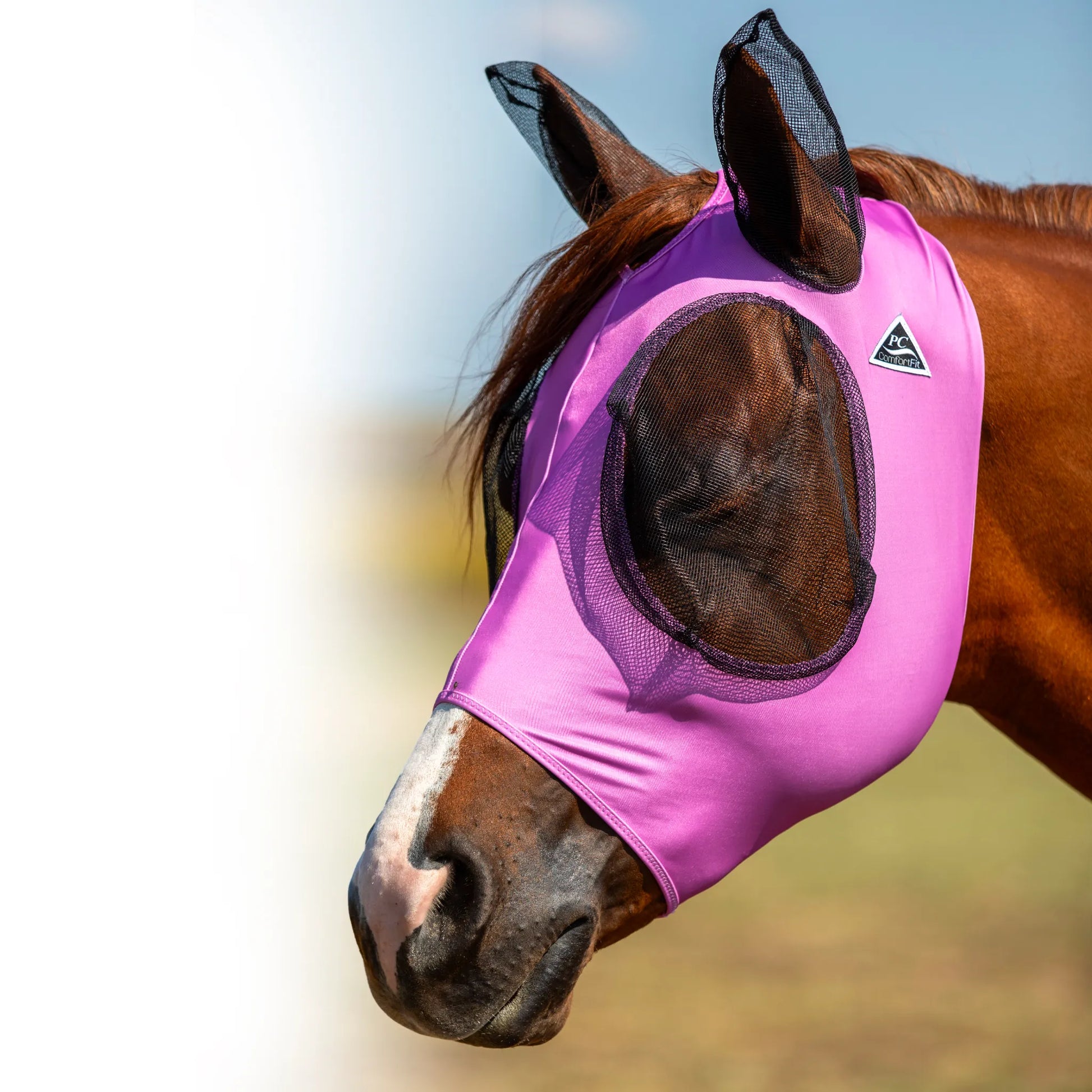 Professional's Choice Comfort-Fit Fly Mask in vibrant pink, featuring breathable mesh eyes and ears for ultimate horse protection against flies and pests. The stretchy, form-fitting fabric ensures a secure and comfortable fit, making it a must-have equestrian accessory for summer turnout. Keep your horse fly-free and protected from UV rays with this stylish, high-quality pink fly mask.