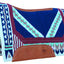 A contoured Western saddle pad featuring a navy blue, maroon, and teal Southwestern pattern on New Zealand wool. It includes a leather-reinforced spine and wear leathers embossed with the Good Medicine logo. The interior is lined with thick, plush cream fleece for comfort and impact protection.
